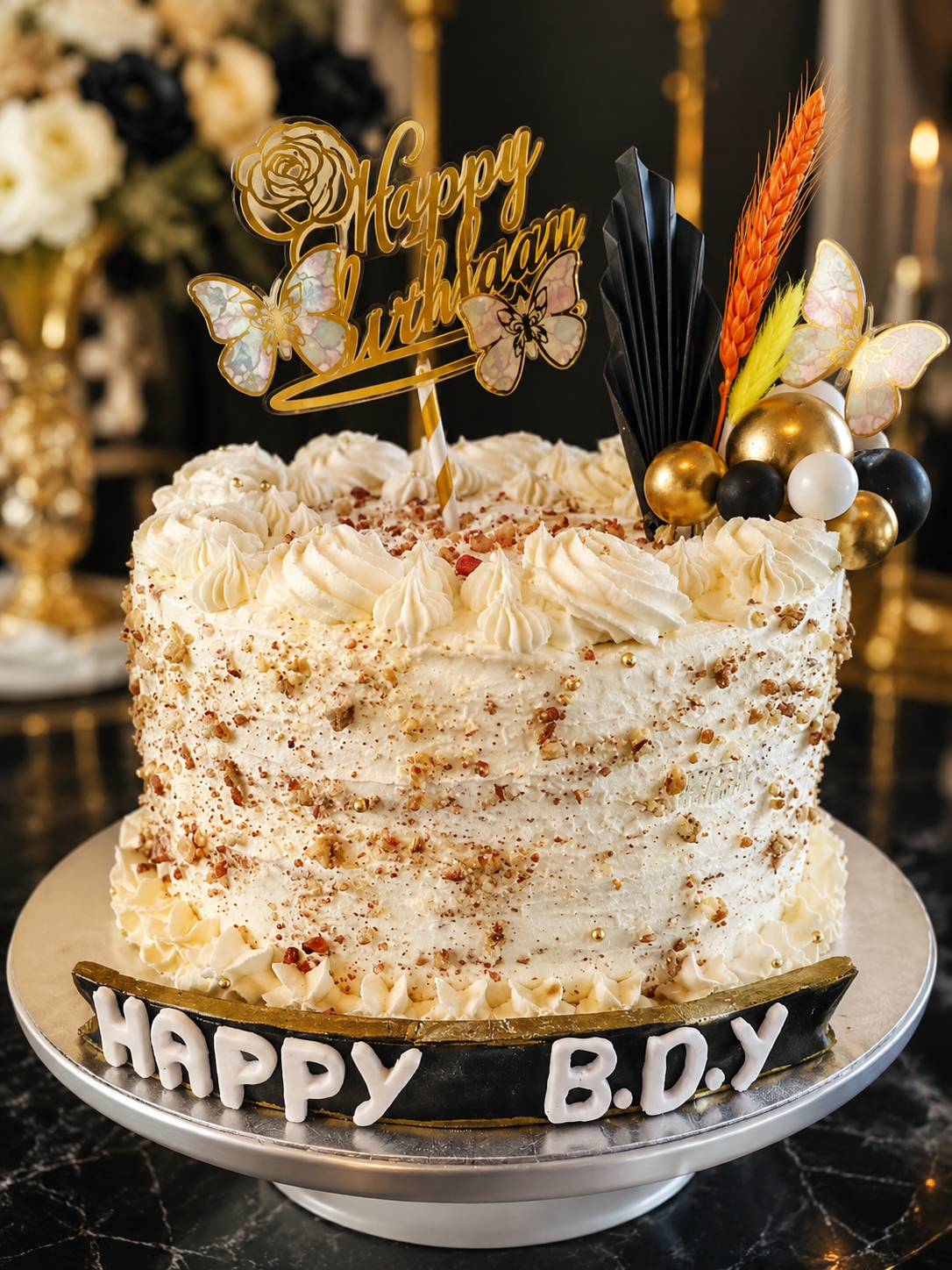 A tall cream celebration cake with happy birthday toppers